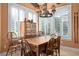 Dining room with farmhouse style table and chairs with bright light from white shuttered windows at 661 Cricklewood Ter, Lake Mary, FL 32746