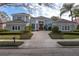 Charming exterior view featuring lush landscaping and a stately entrance, enhancing the home's curb appeal at 661 Cricklewood Ter, Lake Mary, FL 32746