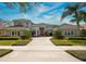 Elegant single-Gathering home with a tile roof, lush landscaping, and a brick driveway at 661 Cricklewood Ter, Lake Mary, FL 32746