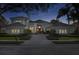 Elegant exterior with a well-maintained lawn and a circular driveway leading to the front entrance at 661 Cricklewood Ter, Lake Mary, FL 32746