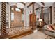Grand foyer showcasing a wooden front door, decorative columns, and tile flooring at 661 Cricklewood Ter, Lake Mary, FL 32746