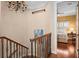 Hallway with decorative staircase and view to the Primary bedroom at 661 Cricklewood Ter, Lake Mary, FL 32746