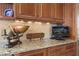 Close up of dark wood cabinets and granite counters show great detail of kitchen decor at 661 Cricklewood Ter, Lake Mary, FL 32746
