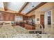 Open concept kitchen features dark wood cabinetry, stainless steel appliances, and breakfast bar at 661 Cricklewood Ter, Lake Mary, FL 32746