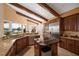 Spacious kitchen with stainless appliances, granite countertops, and beamed ceilings overlooking the water at 661 Cricklewood Ter, Lake Mary, FL 32746