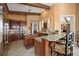 Spacious kitchen with granite countertops, island, stainless steel appliances, wood cabinets and bar seating at 661 Cricklewood Ter, Lake Mary, FL 32746