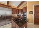 Beautiful kitchen features stainless steel refrigerator, appliances, wood cabinets and island cooktop at 661 Cricklewood Ter, Lake Mary, FL 32746