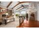 Spacious living room with beamed ceilings, large windows, and a decorative chandelier over the formal dining area at 661 Cricklewood Ter, Lake Mary, FL 32746