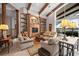 Spacious living room with custom built-ins, wooden beams, and plenty of comfortable seating at 661 Cricklewood Ter, Lake Mary, FL 32746