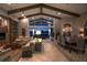 Evening view of a spacious living room featuring beamed ceilings and large windows overlooking the water at 661 Cricklewood Ter, Lake Mary, FL 32746