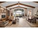 Bright living room with beamed ceilings and lots of natural light flowing in from the oversized picture window at 661 Cricklewood Ter, Lake Mary, FL 32746