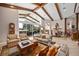 Bright living room with vaulted ceilings, large windows, and seamless access to outdoor views at 661 Cricklewood Ter, Lake Mary, FL 32746