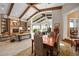 Elegant living room with beamed ceilings, chandelier, and an open dining area filled with natural light at 661 Cricklewood Ter, Lake Mary, FL 32746