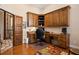 Home office with custom wood cabinetry, built-in desk, and hardwood floors at 661 Cricklewood Ter, Lake Mary, FL 32746