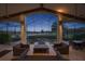 Inviting outdoor patio with beamed ceilings, ceiling fans, and a beautiful lake view at 661 Cricklewood Ter, Lake Mary, FL 32746