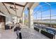 Spacious outdoor patio with dining and seating areas, providing a perfect view of the lake and pool at 661 Cricklewood Ter, Lake Mary, FL 32746