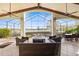 Inviting outdoor patio with beamed ceilings, ceiling fans, and a beautiful lake view at 661 Cricklewood Ter, Lake Mary, FL 32746