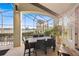 Outdoor dining area on a screened patio with a pool view, perfect for relaxing and entertaining at 661 Cricklewood Ter, Lake Mary, FL 32746