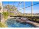 A screened-in pool and spa offer a relaxing outdoor experience with water views at 661 Cricklewood Ter, Lake Mary, FL 32746