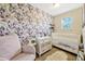 Charming bedroom with floral wallpaper and a crib at 7387 Duxbury Ln, Winter Garden, FL 34787