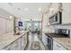 Modern kitchen with granite countertops, stainless steel appliances, and an island at 7387 Duxbury Ln, Winter Garden, FL 34787