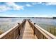 Scenic wooden dock extending over a tranquil lake at 7387 Duxbury Ln, Winter Garden, FL 34787