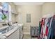 Laundry room with washer, dryer, and hanging rack at 7387 Duxbury Ln, Winter Garden, FL 34787