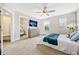 Spacious main bedroom with carpet flooring, large dresser, and ensuite bathroom at 7387 Duxbury Ln, Winter Garden, FL 34787