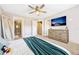 Main bedroom with teal blanket, dresser, and access to ensuite bathroom and hallway at 7387 Duxbury Ln, Winter Garden, FL 34787