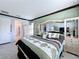 Main bedroom with king bed, dresser, and access to bathroom at 754 San Joaquin Rd, Kissimmee, FL 34759
