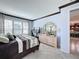Bright bedroom with dresser, large windows, and kitchen view at 754 San Joaquin Rd, Kissimmee, FL 34759