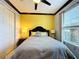 Cozy bedroom with yellow walls, gray bedding, and ample closet space at 754 San Joaquin Rd, Kissimmee, FL 34759