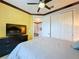 Bright bedroom with yellow walls, gray bedding, and a view of the hallway at 754 San Joaquin Rd, Kissimmee, FL 34759