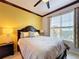 Well-lit guest bedroom with gray bedding and yellow accent wall at 754 San Joaquin Rd, Kissimmee, FL 34759