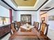 Formal dining room with a large wood table and decorative ceiling at 754 San Joaquin Rd, Kissimmee, FL 34759