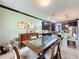 Bright dining room features a spacious table with glass top and dark wood chairs at 754 San Joaquin Rd, Kissimmee, FL 34759