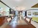 Elegant dining room with large glass-top table and view into the kitchen at 754 San Joaquin Rd, Kissimmee, FL 34759