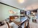 Bright dining room features a spacious table with glass top and dark wood chairs at 754 San Joaquin Rd, Kissimmee, FL 34759