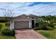 House exterior with a two-car garage and brick driveway at 754 San Joaquin Rd, Kissimmee, FL 34759