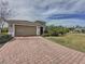 Brick paver driveway leads to a one-story home with attached garage at 754 San Joaquin Rd, Kissimmee, FL 34759