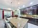 Modern kitchen with granite island and dark wood cabinets at 754 San Joaquin Rd, Kissimmee, FL 34759