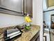 Kitchen counter with granite top, small appliances, and a fruit bowl at 754 San Joaquin Rd, Kissimmee, FL 34759