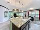 Kitchen island with granite countertop and sink, overlooking the dining and living areas at 754 San Joaquin Rd, Kissimmee, FL 34759