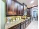 Kitchen with granite countertops, dark wood cabinets, and a built in microwave at 754 San Joaquin Rd, Kissimmee, FL 34759