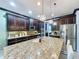 Bright kitchen with granite island, dark cabinetry, and stainless steel appliances at 754 San Joaquin Rd, Kissimmee, FL 34759