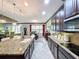 Open kitchen with granite island, stainless steel appliances, and breakfast bar at 754 San Joaquin Rd, Kissimmee, FL 34759