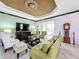 Spacious living room with green sofa, patterned chairs, and backyard access at 754 San Joaquin Rd, Kissimmee, FL 34759