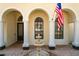 Elegant entryway with arched entry, columns and a central water fountain at 842 Palm Oak Dr, Apopka, FL 32712