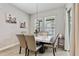 Casual dining area with a marble table and six modern chairs at 8719 Crescendo Ave, Windermere, FL 34786