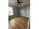 Bright bedroom with wood-look floors and ceiling fan at 984 Maypole Dr, Apopka, FL 32703